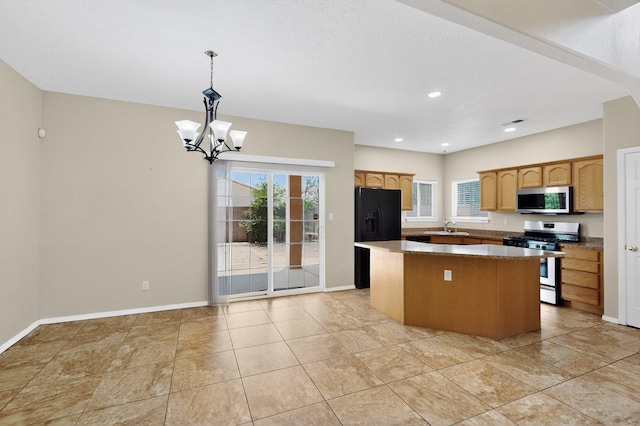 5508 Carefree Ave NW, Albuquerque, NM 87120 - kitchen with appliances with stainless steel finishes, a center island, a chandelier, hanging light fixtures, and recessed lighting
