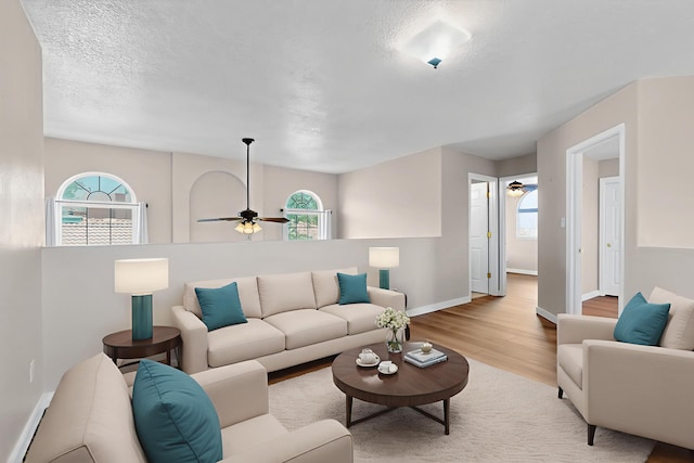 5508 Carefree Ave NW, Albuquerque, NM 87120 - living area with a ceiling fan, wood finished floors, healthy amount of natural light, and a textured ceiling
