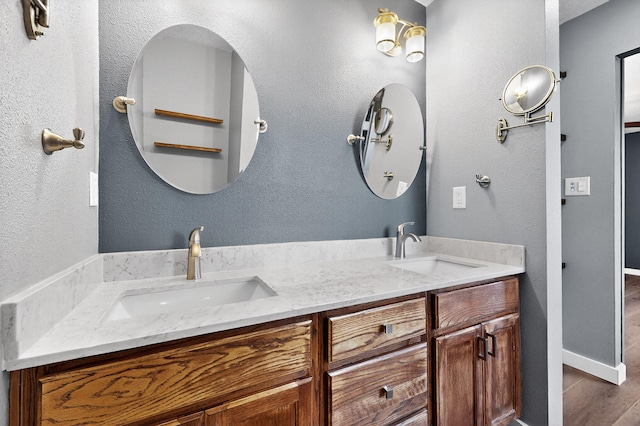 5508 Carefree Ave NW, Albuquerque, NM 87120 - full bathroom featuring double vanity and wood finished floors