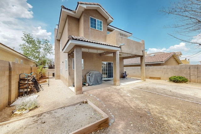 5508 Carefree Ave NW, Albuquerque, NM 87120 - back of property with stucco siding, a tile roof, a fenced backyard, and a patio