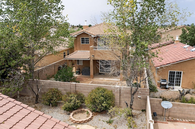 5508 Carefree Ave NW, Albuquerque, NM 87120 - view of front of home with a tiled roof, stucco siding, a fenced backyard, a patio, and a chimney