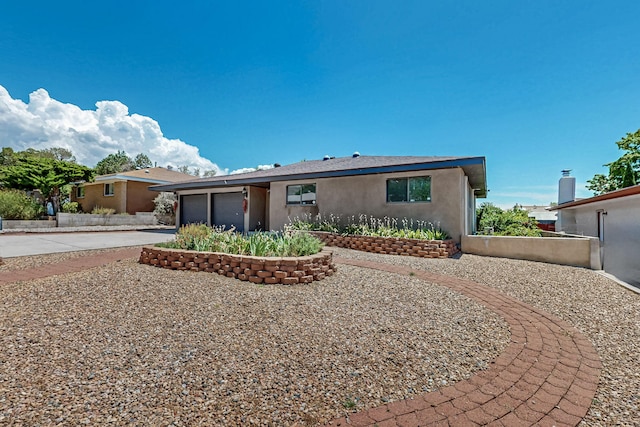 12208 Phoenix Ave NE, Albuquerque, NM 87112 - ranch-style home with driveway, a garage, and stucco siding