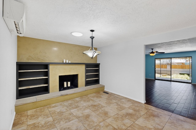 12208 Phoenix Ave NE, Albuquerque, NM 87112 - unfurnished living room featuring an AC wall unit, a fireplace with raised hearth, ceiling fan, a textured ceiling, and built in features