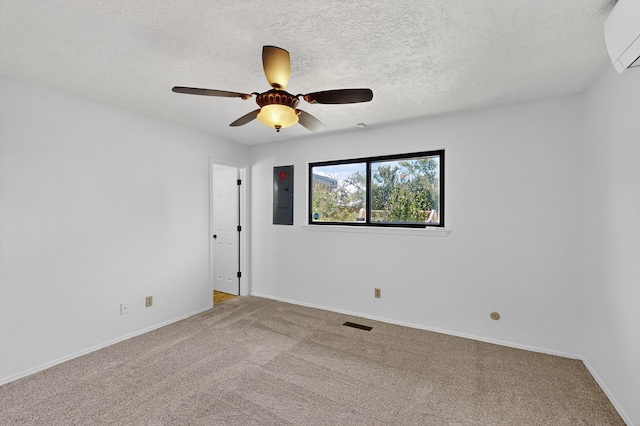 12208 Phoenix Ave NE, Albuquerque, NM 87112 - empty room with electric panel, an AC wall unit, carpet, a ceiling fan, and a textured ceiling
