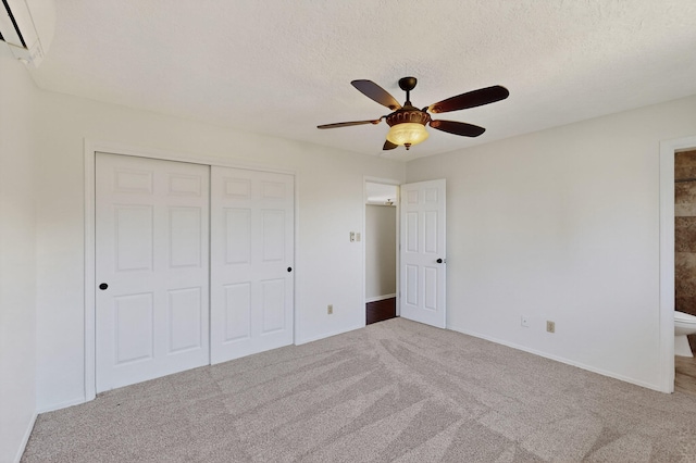 12208 Phoenix Ave NE, Albuquerque, NM 87112 - unfurnished bedroom featuring carpet, a closet, a wall mounted air conditioner, ceiling fan, and a textured ceiling