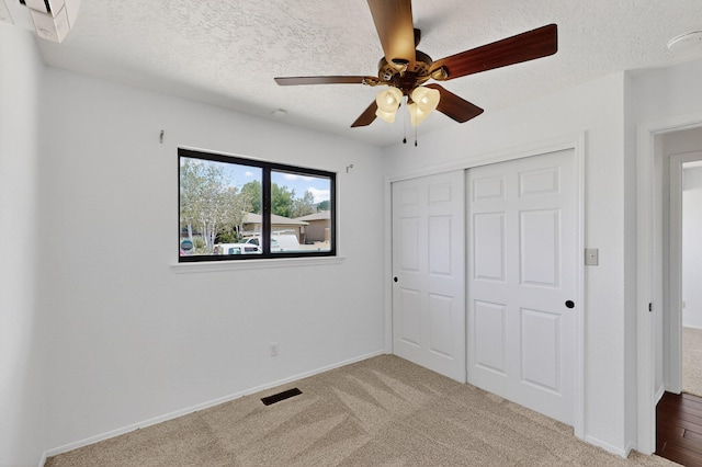 12208 Phoenix Ave NE, Albuquerque, NM 87112 - unfurnished bedroom with a closet, a textured ceiling, carpet flooring, and a ceiling fan