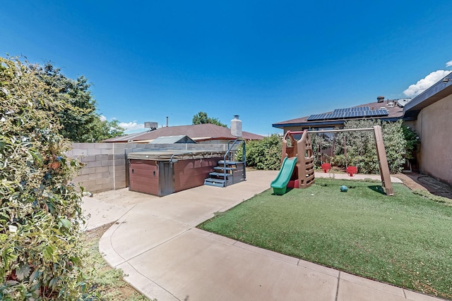 12208 Phoenix Ave NE, Albuquerque, NM 87112 - fenced backyard with a hot tub, a playground, and a patio area