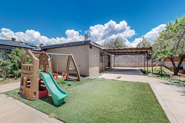 12208 Phoenix Ave NE, Albuquerque, NM 87112 - view of play area with a patio