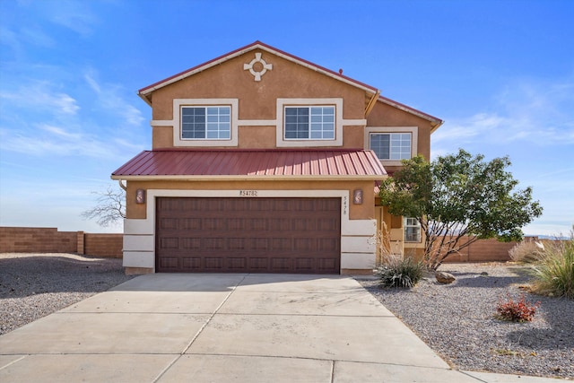 5478 Salem Ct NE, Rio Rancho, NM 87144 - view of front of home featuring stucco siding, driveway, a metal roof, and a garage