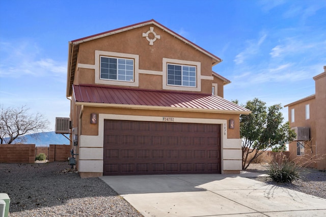 5478 Salem Ct NE, Rio Rancho, NM 87144 - view of front facade with concrete driveway, a metal roof, a garage, and stucco siding