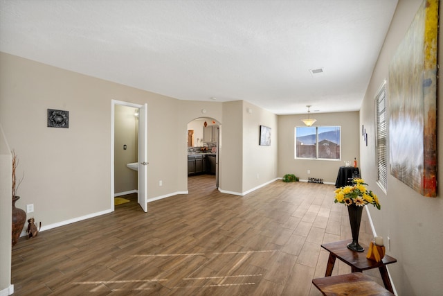 5478 Salem Ct NE, Rio Rancho, NM 87144 - unfurnished living room with dark wood finished floors and arched walkways