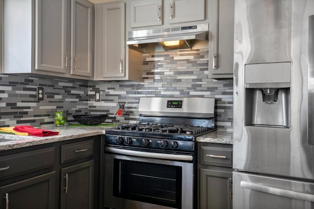 5478 Salem Ct NE, Rio Rancho, NM 87144 - kitchen with appliances with stainless steel finishes, under cabinet range hood, decorative backsplash, gray cabinets, and light stone countertops