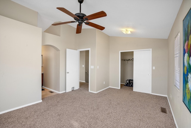 5478 Salem Ct NE, Rio Rancho, NM 87144 - unfurnished bedroom featuring vaulted ceiling, arched walkways, carpet flooring, a closet, and ceiling fan
