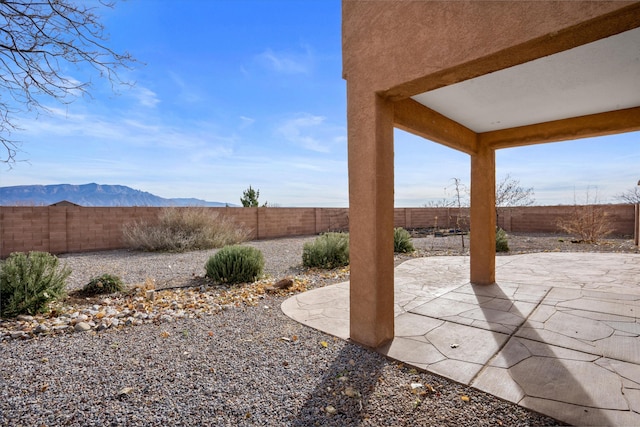 5478 Salem Ct NE, Rio Rancho, NM 87144 - fenced backyard featuring a patio area and a mountain view