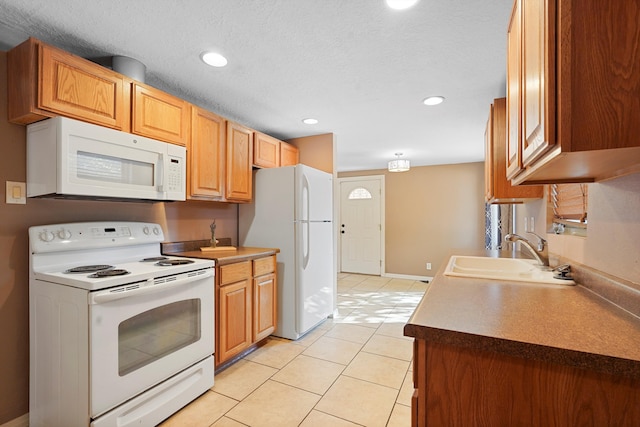 1048 Betts St NE, Albuquerque, NM 87112 - kitchen featuring white appliances, light tile patterned floors, and recessed lighting