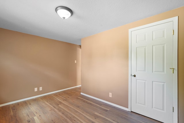 1048 Betts St NE, Albuquerque, NM 87112 - unfurnished room featuring wood finished floors and a textured ceiling