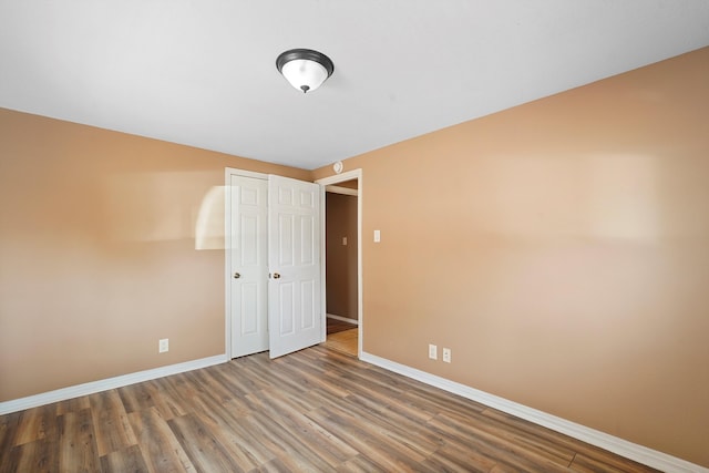 1048 Betts St NE, Albuquerque, NM 87112 - unfurnished bedroom with wood finished floors and a closet