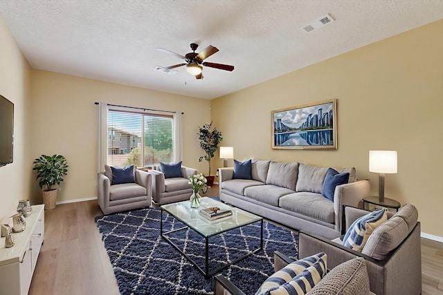 11008 Marina Gate Trl NE, Albuquerque, NM 87123 - living area with a ceiling fan, light wood-style floors, and a textured ceiling