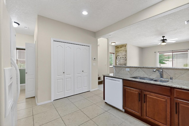 11008 Marina Gate Trl NE, Albuquerque, NM 87123 - kitchen featuring dishwasher, a textured ceiling, light tile patterned floors, light stone counters, and a ceiling fan