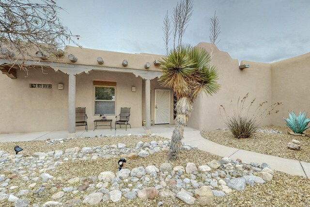 39 Pine Rd, Placitas, NM 87043 - view of exterior entry featuring stucco siding