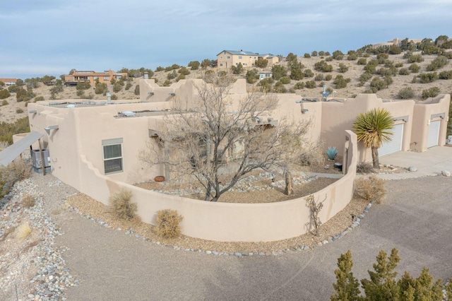 39 Pine Rd, Placitas, NM 87043 - rear view of property featuring concrete driveway and stucco siding