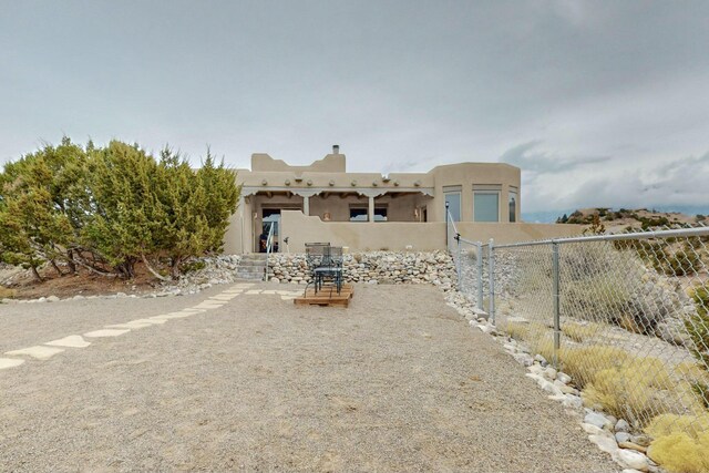 39 Pine Rd, Placitas, NM 87043 - view of front of property with stucco siding and a chimney