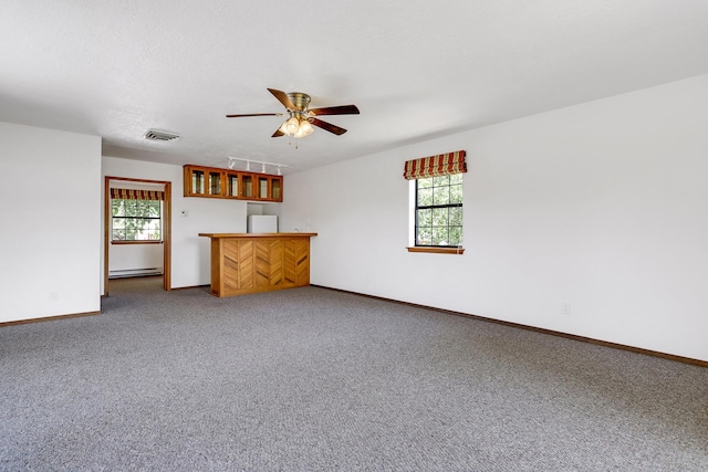 10128 Guadalupe Trl NW, Albuquerque, NM 87114 - unfurnished living room featuring ceiling fan, carpet floors, and a baseboard radiator