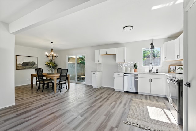 11517 San Jacinto Ave NE, Albuquerque, NM 87112 - kitchen featuring appliances with stainless steel finishes, plenty of natural light, light wood finished floors, and a chandelier