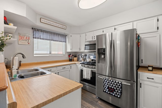 121 Pearl Dr NE, Rio Rancho, NM 87124 - kitchen featuring appliances with stainless steel finishes, white cabinetry, and dark wood-type flooring