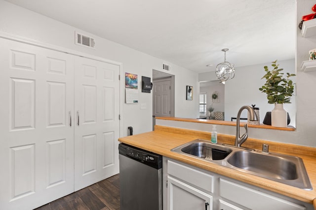121 Pearl Dr NE, Rio Rancho, NM 87124 - kitchen with dishwasher, light countertops, dark wood-style flooring, white cabinetry, and decorative light fixtures