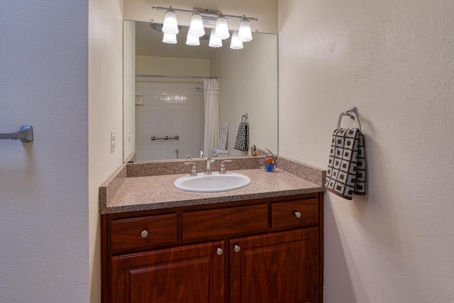 9201 Academy Hills Dr NE, Albuquerque, NM 87111 - bathroom with vanity, a textured wall, and a shower with curtain