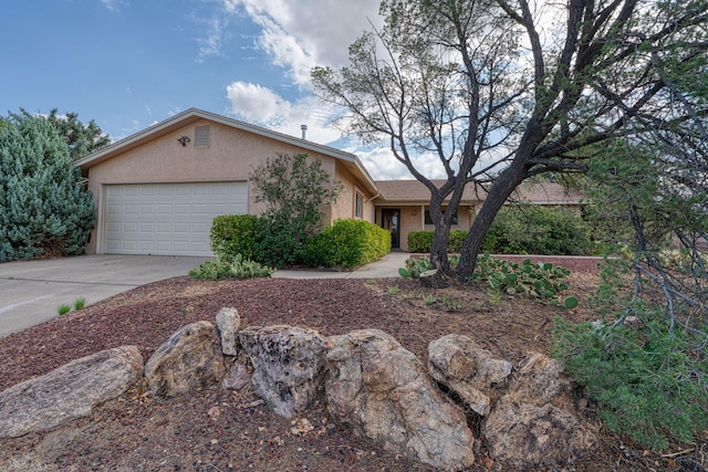 9201 Academy Hills Dr NE, Albuquerque, NM 87111 - ranch-style home with stucco siding, an attached garage, and driveway