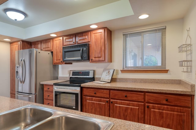9201 Academy Hills Dr NE, Albuquerque, NM 87111 - kitchen featuring appliances with stainless steel finishes, brown cabinetry, recessed lighting, and light countertops