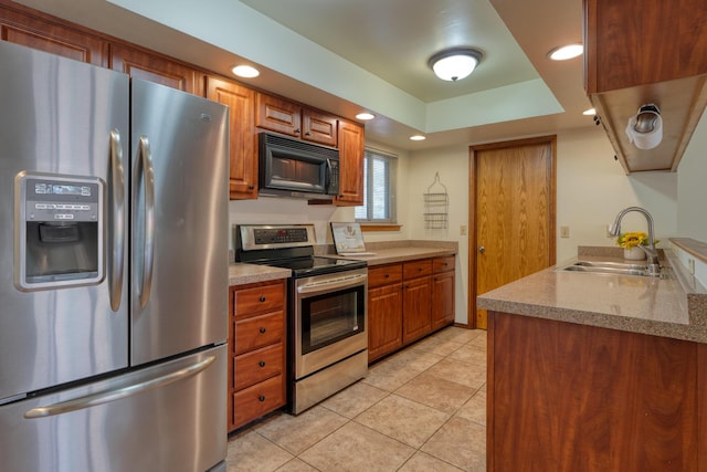 9201 Academy Hills Dr NE, Albuquerque, NM 87111 - kitchen featuring appliances with stainless steel finishes, brown cabinets, light tile patterned floors, recessed lighting, and light stone counters