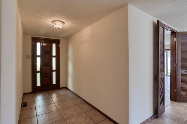 9201 Academy Hills Dr NE, Albuquerque, NM 87111 - foyer entrance featuring a textured ceiling and light tile patterned flooring
