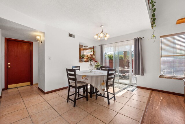 7824 Snowberry St NW, Albuquerque, NM 87120 - dining area featuring a chandelier and light tile patterned floors