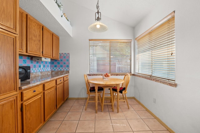 7824 Snowberry St NW, Albuquerque, NM 87120 - dining space with lofted ceiling and light tile patterned floors