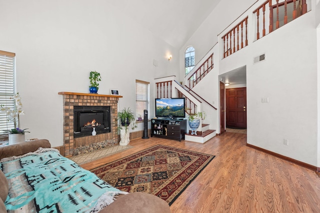 7824 Snowberry St NW, Albuquerque, NM 87120 - living room with high vaulted ceiling, wood finished floors, a fireplace, and stairs