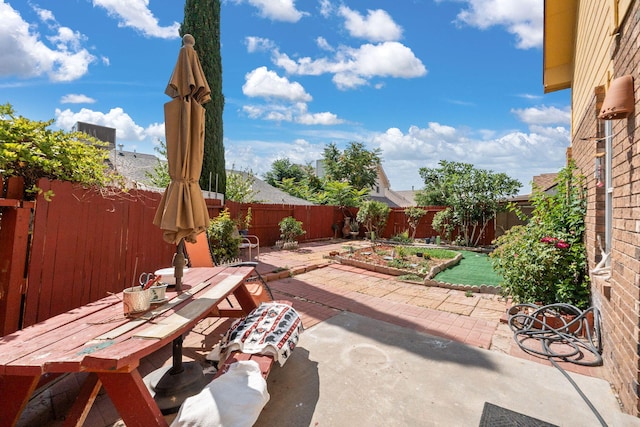 7824 Snowberry St NW, Albuquerque, NM 87120 - fenced backyard with a patio area, outdoor dining space, and a vegetable garden
