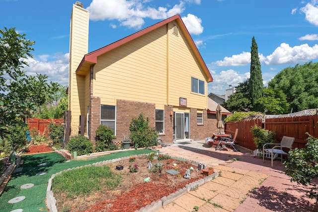 7824 Snowberry St NW, Albuquerque, NM 87120 - back of property with brick siding, a patio, a chimney, and a fenced backyard
