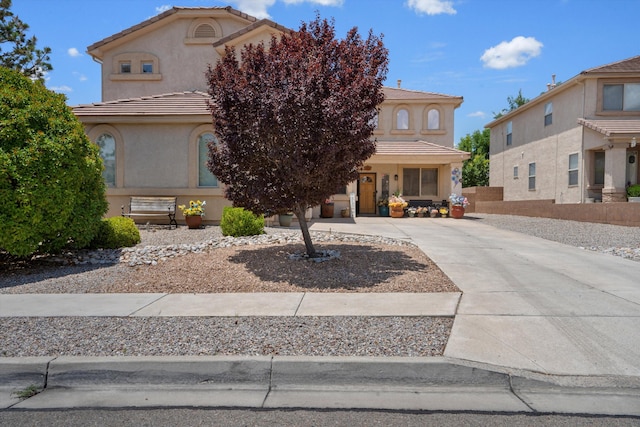 1417 Montiano Loop SE, Rio Rancho, NM 87124 - view of front of home with stucco siding, a tile roof, and driveway