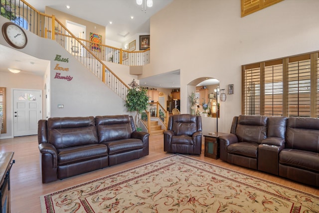 1417 Montiano Loop SE, Rio Rancho, NM 87124 - living area with a towering ceiling, wood finished floors, stairway, arched walkways, and plenty of natural light