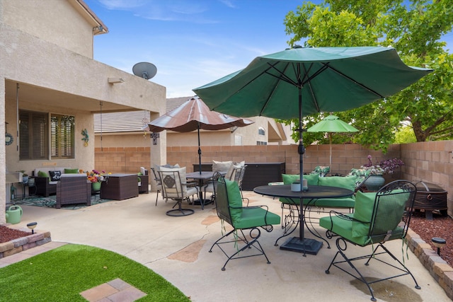 1417 Montiano Loop SE, Rio Rancho, NM 87124 - fenced backyard with an outdoor hangout area, outdoor dining area, and a patio
