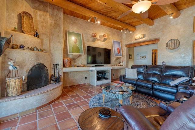 15 Sunset Blvd, Placitas, NM 87043 - tiled living area with a wooden ceiling with exposed beams, a fireplace with raised hearth, and ceiling fan