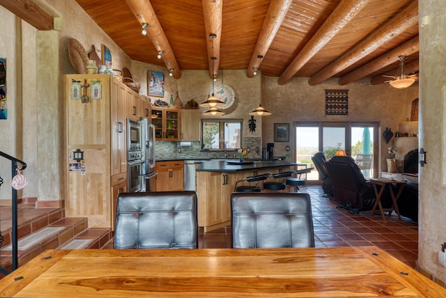 15 Sunset Blvd, Placitas, NM 87043 - kitchen with a wood ceiling with exposed beams, dark countertops, glass insert cabinets, stainless steel appliances, and a breakfast bar area