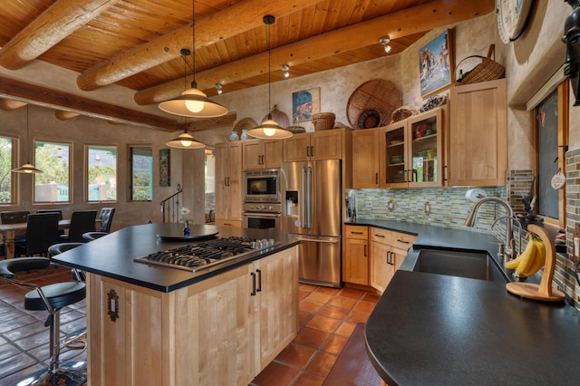 15 Sunset Blvd, Placitas, NM 87043 - kitchen featuring appliances with stainless steel finishes, dark countertops, a wood ceiling with exposed beams, dark tile patterned floors, and decorative backsplash