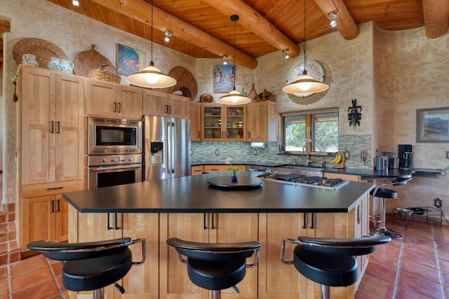 15 Sunset Blvd, Placitas, NM 87043 - kitchen with appliances with stainless steel finishes, a wood ceiling with exposed beams, dark countertops, a center island, and glass insert cabinets