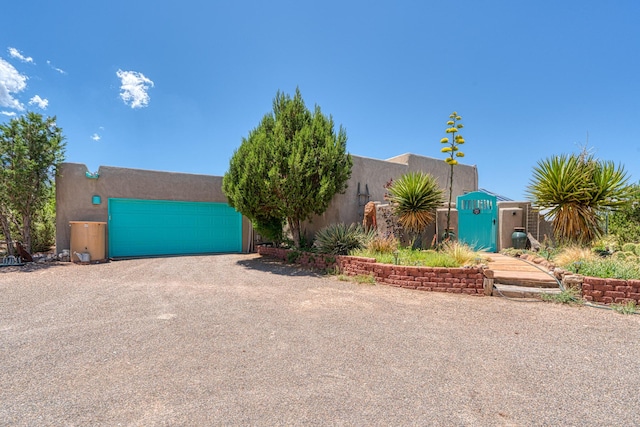 15 Sunset Blvd, Placitas, NM 87043 - southwest-style home featuring dirt driveway, stucco siding, and an attached garage
