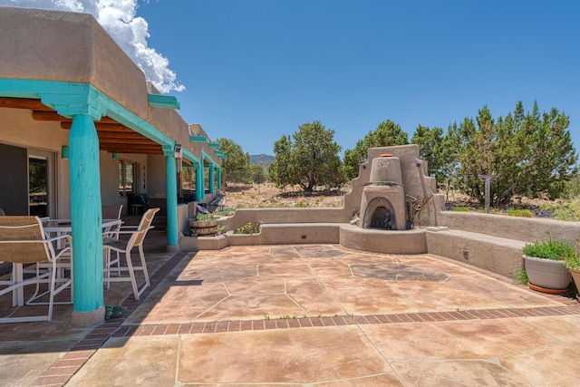 15 Sunset Blvd, Placitas, NM 87043 - view of patio / terrace featuring exterior fireplace