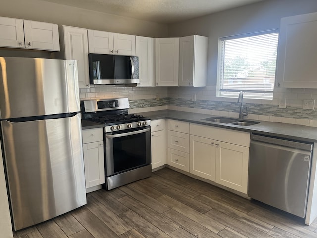 3005 Quail Point Dr, Albuquerque, NM 87120 - kitchen featuring appliances with stainless steel finishes, white cabinets, and backsplash